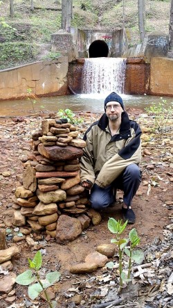 DEWnada building cairn at Aum Gyre Grove