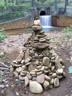 Cairn from behind with waterfall view